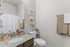 Modern and sleek bathroom featuring granite countertops, elegant fixtures, and stylish decor.