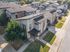 Modern apartment complex with contemporary architecture, lush green landscaping, and convenient parking in a vibrant neighborhood.