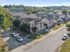 Charming residential neighborhood with modern townhouses, lush greenery, and ample parking, offering a peaceful suburban lifestyle.