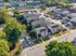 Charming residential neighborhood showcasing modern townhomes with lush green surroundings and convenient parking.