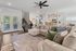 Elegant and cozy living room with plush sectional sofa, open-concept kitchen, and stylish dining area, perfect for modern living.