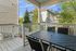 Charming porch view with outdoor dining area overlooking a serene neighborhood scene.