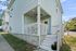 Charming home exterior with a cozy front porch, elegant railing, and inviting entrance.