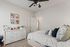 Charming bedroom with elegant neutral tones, stylish decor, and cozy atmosphere.