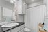 Charming bathroom with sleek counter, elegant fixtures, and smart storage solutions.