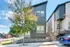 Modern duplex with sleek architecture, large windows, and landscaped entry, perfect for urban living enthusiasts.