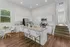 Bright and modern kitchen with sleek granite countertops, stylish island seating, and elegant dining area, perfect for entertaining.