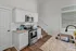 Modern kitchen featuring sleek stainless steel appliances, elegant granite countertops, and inviting natural light.