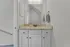 Elegant bathroom vanity with granite countertop, sleek fixtures, and modern lighting.