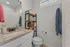 Modern bathroom with elegant granite countertop and storage solutions, highlighting bright and inviting ambiance.