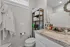 Chic bathroom with elegant granite countertop, ample storage space, and modern fixtures.