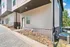 Charming corner view of a modern apartment exterior with sleek siding and brick accents, showcasing a well-maintained entrance and clean landscaping.