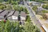 Aerial view of modern townhouses nestled in a lush, green neighborhood, showcasing convenient parking and nearby amenities for an ideal urban living experience.