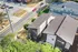 Charming aerial view of modern apartment buildings surrounded by lush greenery and a vibrant neighborhood, showcasing urban living at its best.