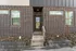 Charming entryway with brick exterior and modern glass door, perfect for welcoming guests with style.