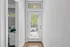 Bright entryway with sleek glass door and modern blinds, leading to a welcoming interior office space with contemporary design.