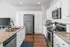 Chic modern kitchen with granite countertops, sleek stainless steel appliances, and elegant white cabinetry.
