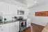 Bright and inviting modern kitchen featuring sleek white cabinets, stainless steel appliances, and elegant granite countertops.