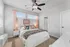 Cozy and elegant bedroom featuring a plush bed with chic pillows, soft lighting, and stylish decor in soothing tones.