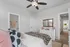 Charming bedroom with elegant decor, featuring a cozy bed, stylish pillows, ornate mirror, and inviting natural light.