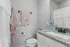Elegant bathroom with modern granite countertop, stylish white cabinetry, and tasteful decor, perfect for a serene retreat.