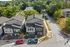 Charming aerial view of modern duplex homes surrounded by lush greenery, offering a serene neighborhood vibe.