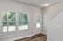 Bright entryway with modern decor, natural light, and sleek hardwood floors.