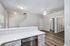 Modern open-concept kitchen with sleek countertops, stainless steel appliances, and elegant hardwood flooring.