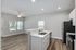 Bright and modern open-concept kitchen and living area with sleek countertops, stainless steel appliances, and ambient lighting.