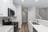 Sleek modern kitchen with stainless steel appliances, elegant white cabinetry, and stylish hardwood flooring for a contemporary feel.