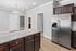 Modern kitchen space with sleek stainless steel appliances, elegant granite countertops, and rich dark wood cabinets, offering a luxurious and functional cooking area.
