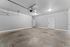 Spacious garage with smooth concrete floor and ample lighting, perfect for parking or storage solutions.
