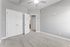 Inviting bedroom with plush carpeting, soft gray walls, and bright white doors, offering a serene canvas for personalization.