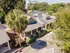Charming suburban street with cozy bungalow-style homes surrounded by lush greenery and a sunny ambiance.