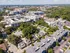 Vibrant aerial view of a bustling urban landscape featuring modern apartment complexes surrounded by lush greenery, capturing the essence of lively city living.