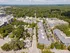 Vibrant aerial view of a tree-lined neighborhood featuring modern apartment complexes and lush greenery, offering a serene residential ambiance.