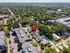 Vibrant aerial view of a charming neighborhood highlighting a desirable property with lush surroundings and modern amenities nearby.