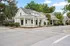 Charming suburban street with picturesque houses, lush greenery, and a welcoming porch, offering timeless architectural elegance.