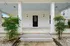 Inviting front porch with elegant columns and charming lantern lights, perfect for relaxing outdoor moments.