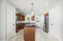 Modern kitchen with sleek granite countertops, stainless steel appliances, and elegant wooden cabinetry for a stylish cooking experience.