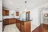 Modern kitchen featuring rich wooden cabinetry, elegant granite countertops, and sleek stainless steel appliances, exuding warmth and style.