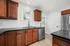 Modern kitchen with elegant dark countertops, rich wooden cabinets, and sleek stainless steel appliances.