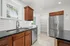 Modern kitchen with stainless steel appliances, polished granite countertops, and elegant wooden cabinetry.