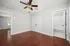 Elegant room with rich hardwood floors, built-in ceiling fan, and a freshly tiled bathroom with classic subway tiles.