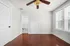 Bright and airy room with elegant hardwood floors, modern ceiling fan, and direct access to a chic tiled bathroom.