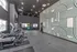 Modern gym with state-of-the-art treadmills, vibrant exercise balls, and striking geometric wall design for an energizing workout ambiance.