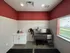 Modern pet washing station with sleek stainless-steel tub, stylish red walls, and natural light from a large window.