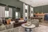 Elegant living space featuring a luxurious brown leather sofa, stylish modern coffee table, and open kitchen with chic pendant lighting and sleek appliances.
