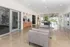Modern apartment lobby with sleek design, cozy seating, polished floors, and abundant natural light.
