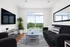 Bright, modern living room with large windows, a sleek sofa, and a view of lush greenery, perfect for relaxation and entertaining.